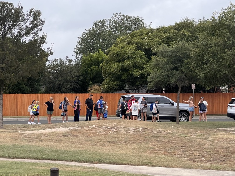 parents and students gather near the school for drop off