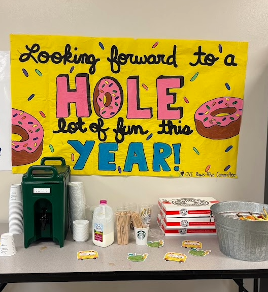 Picture of coffee on a table with sign behind it.