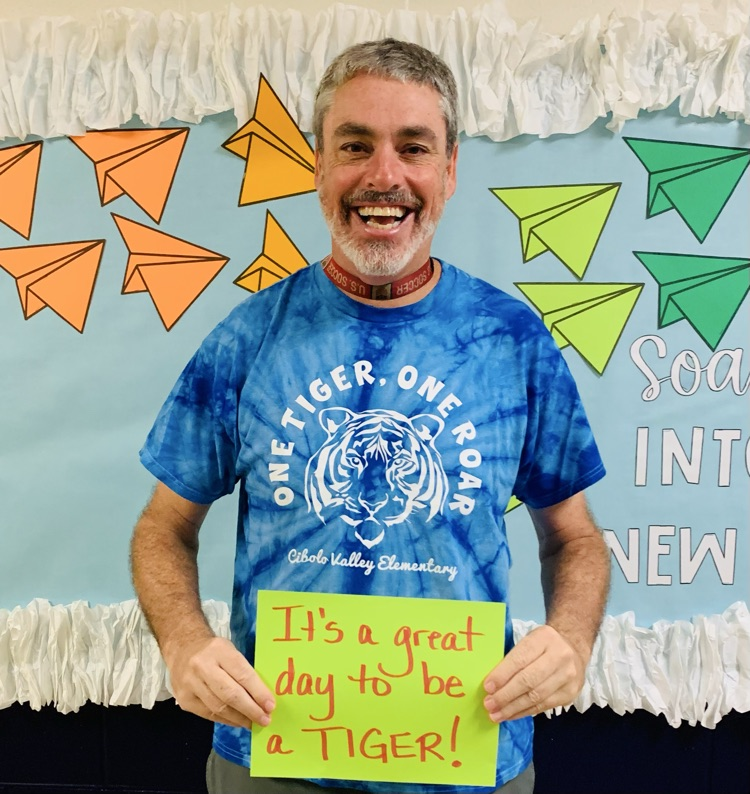 Teacher holding sign
