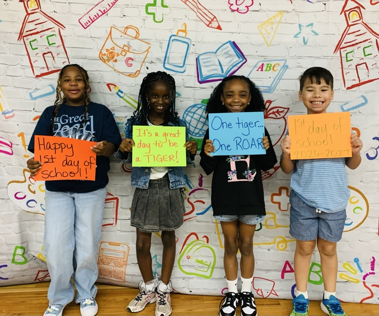 4 students holding signs