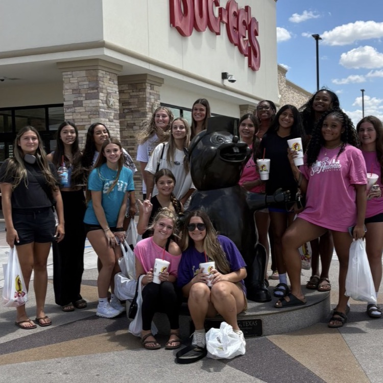 volleyball girls at a buccees holding snacks and bags.