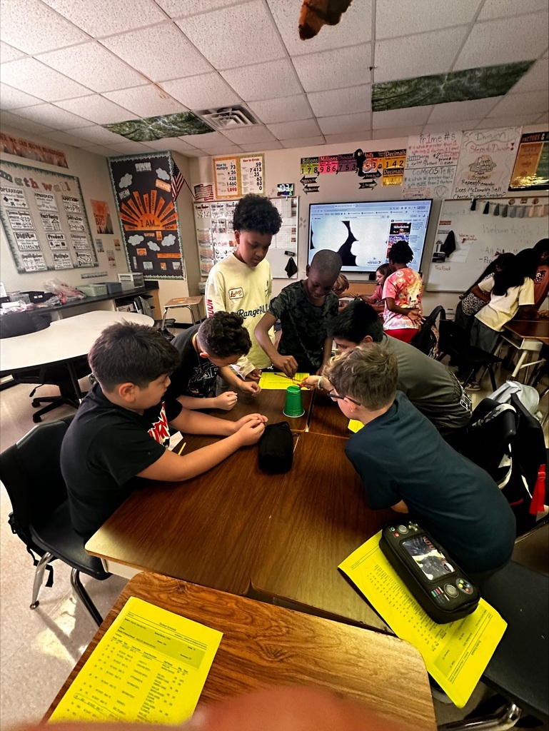 students working together on a team building activity in Ms Dixon's Math class