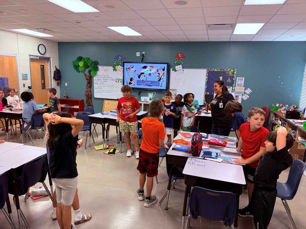 Students working in groups in a classroom.