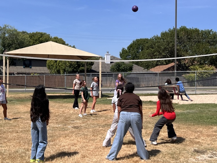 girls playing volleyball on the playground
