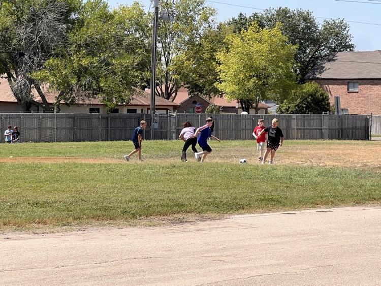 kids playing soccer during recess