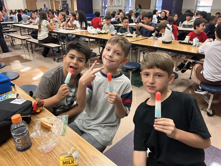 three boys eating popsicles