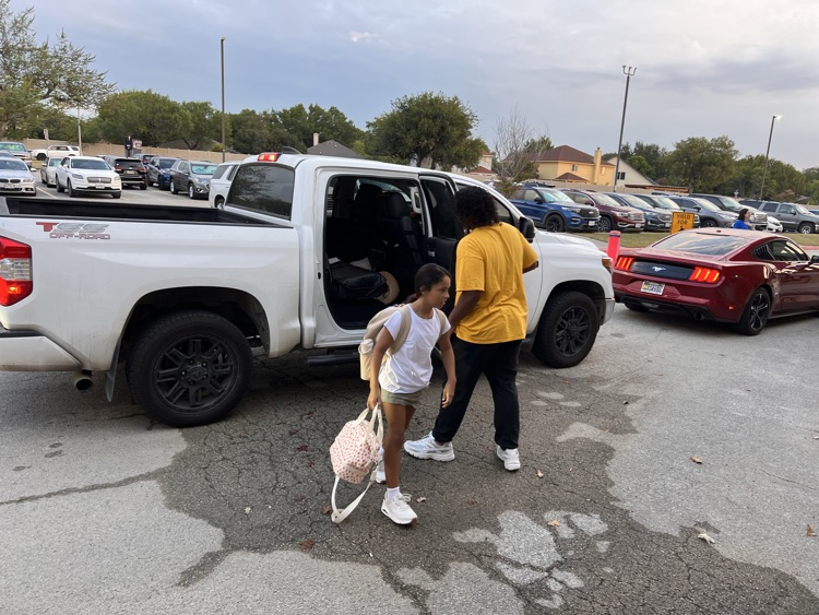 high schooler opening car door for student 