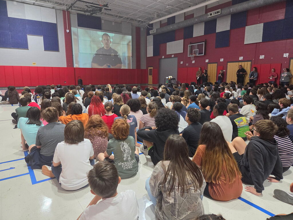 students sitting in an assembly
