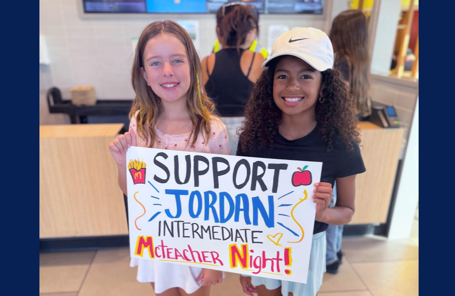students posing together with a sign advertising McTeacher Night