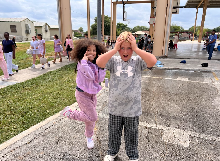 a boy and girl being silly outside
