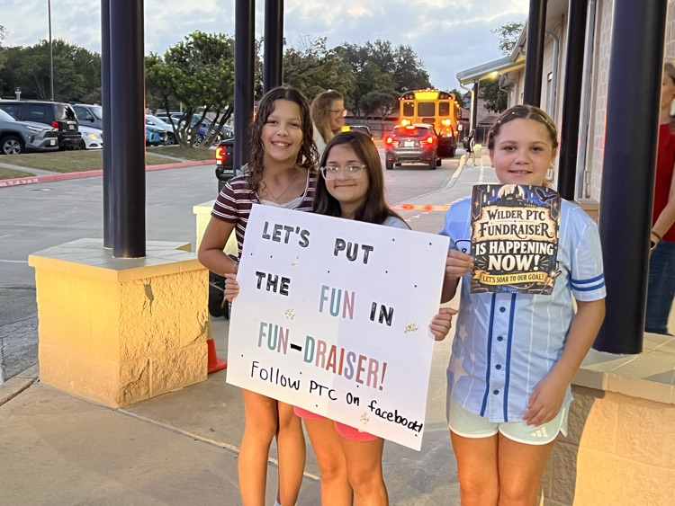 3 girls with a fundraiser sign
