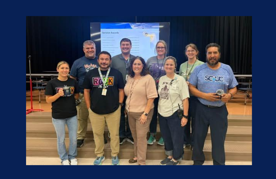 picture of teachers and staff holding their Years of Service award
