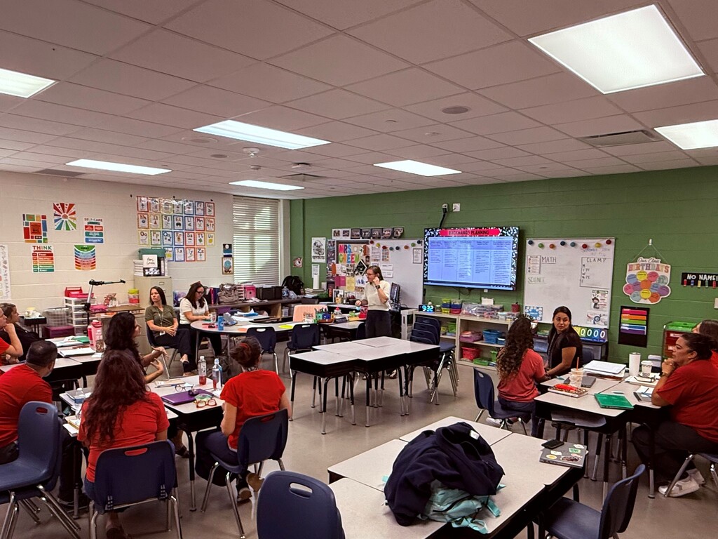 Teachers meeting in classroom.
