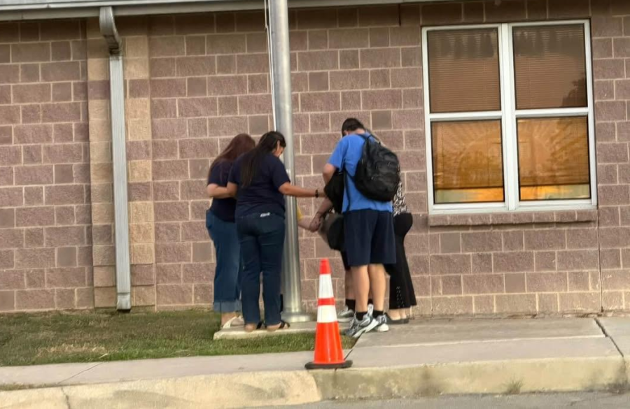 students and teachers gather around the flagpole in prayer for See You at the Pole