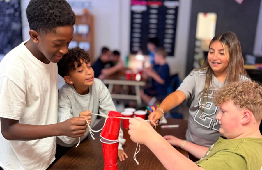 picture of students working on a science lab together