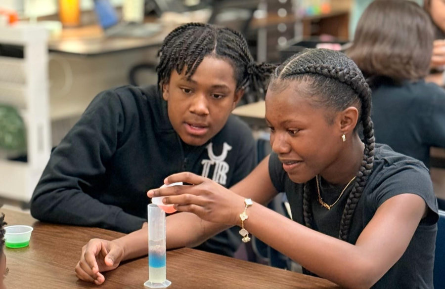 picture of students working on a science lab together