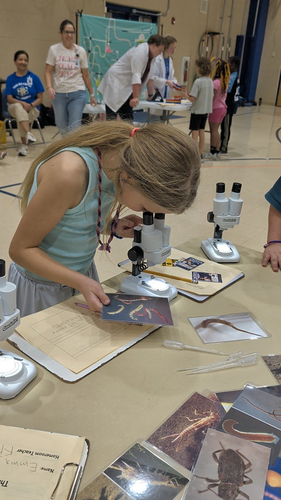 student looking through microscope