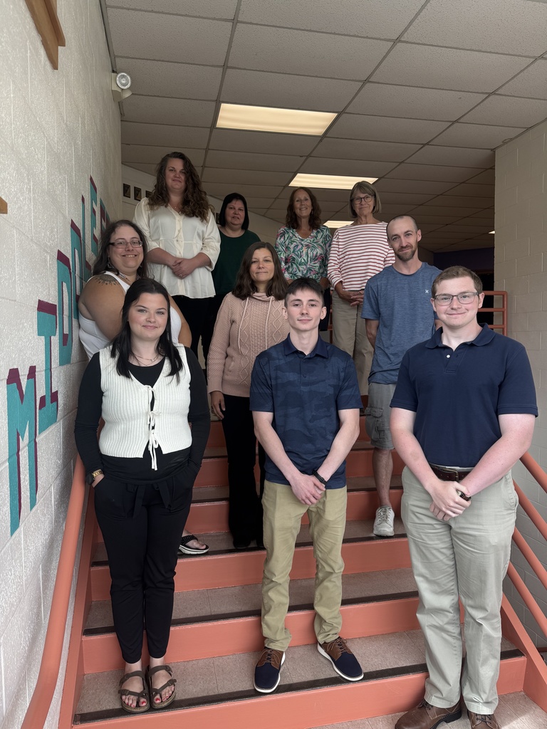 New Staff Photo with teachers standing on chairs