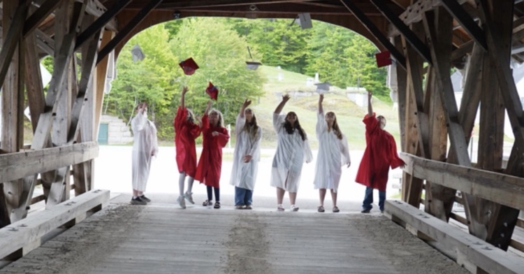 graduating students on bridge