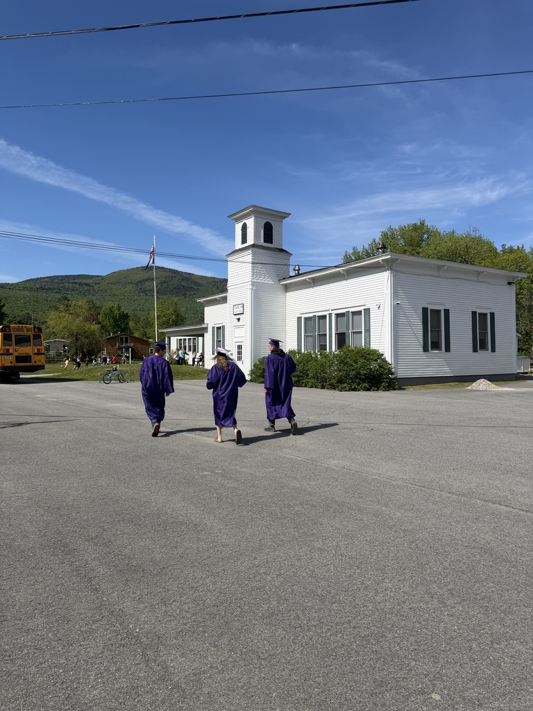 graduating seniors standing outside school