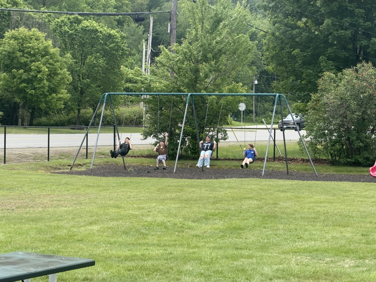 student playing on swings