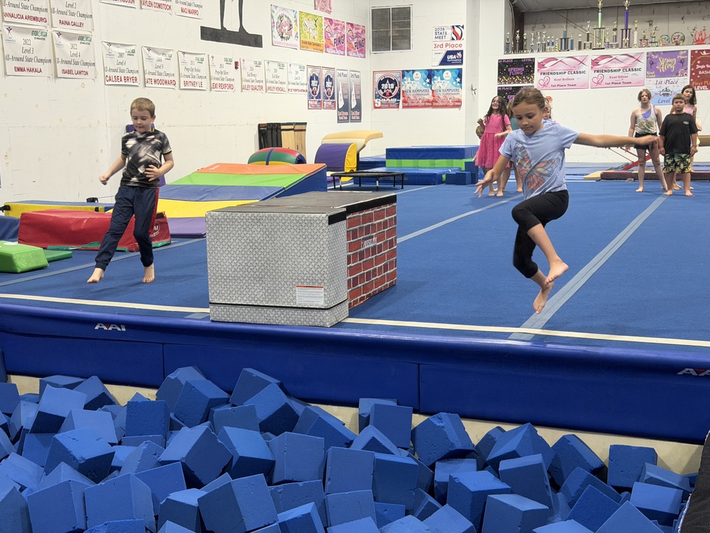 students jumping into foam pit