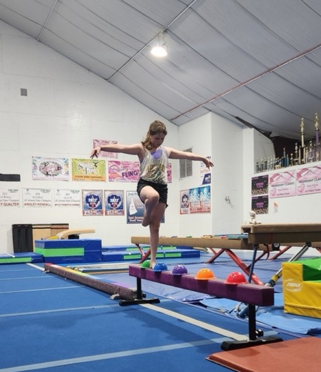 student balancing on beam