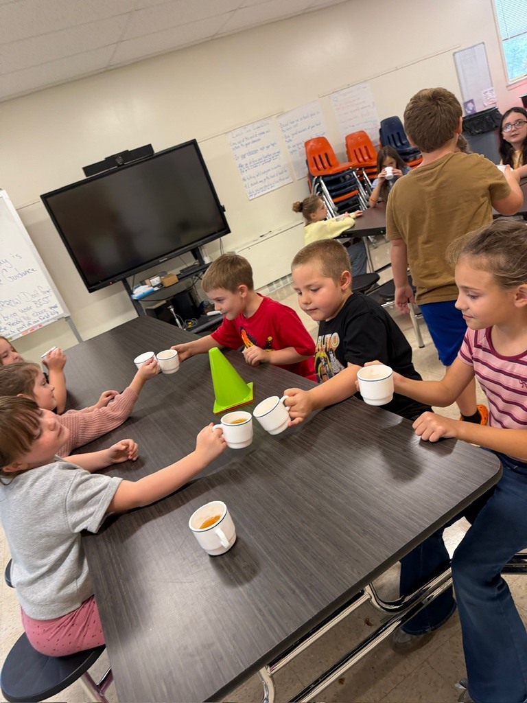 students clinking cups of cider