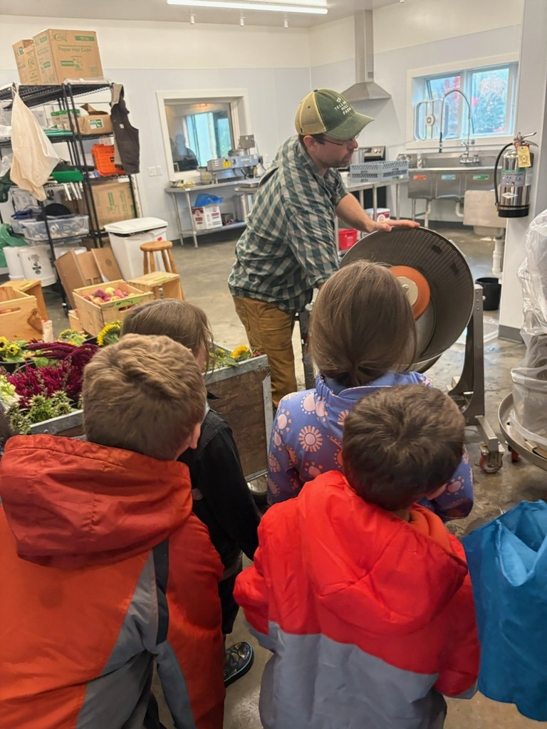 students looking at apple press