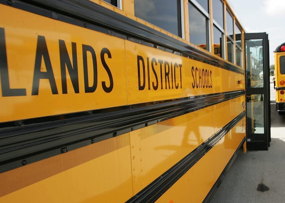 Picture of a yellow school bus that is listed as Highlands District Schools
