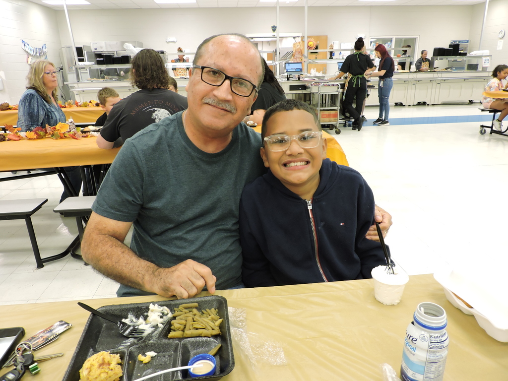 parents/guardians with students at Thanksgiving Luncheon