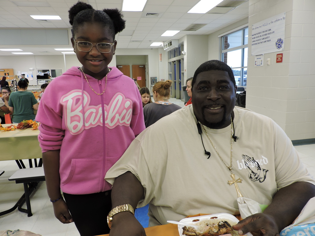 parents/guardians with students at Thanksgiving Luncheon