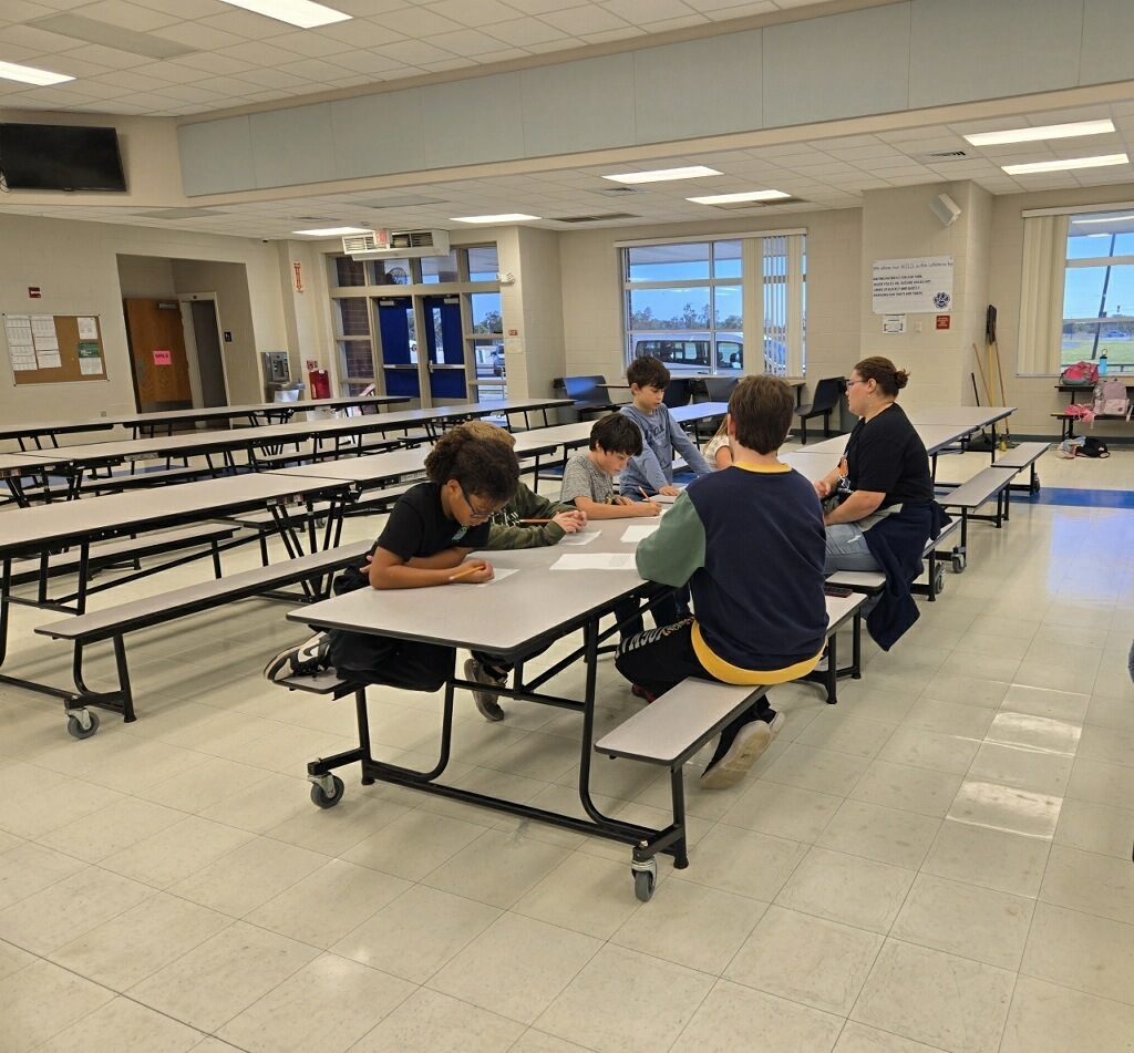 SHS creative writing group and FWE daycare kids working on their stories