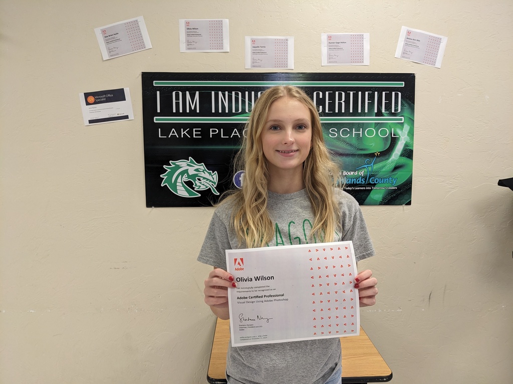 Student holding certificate.