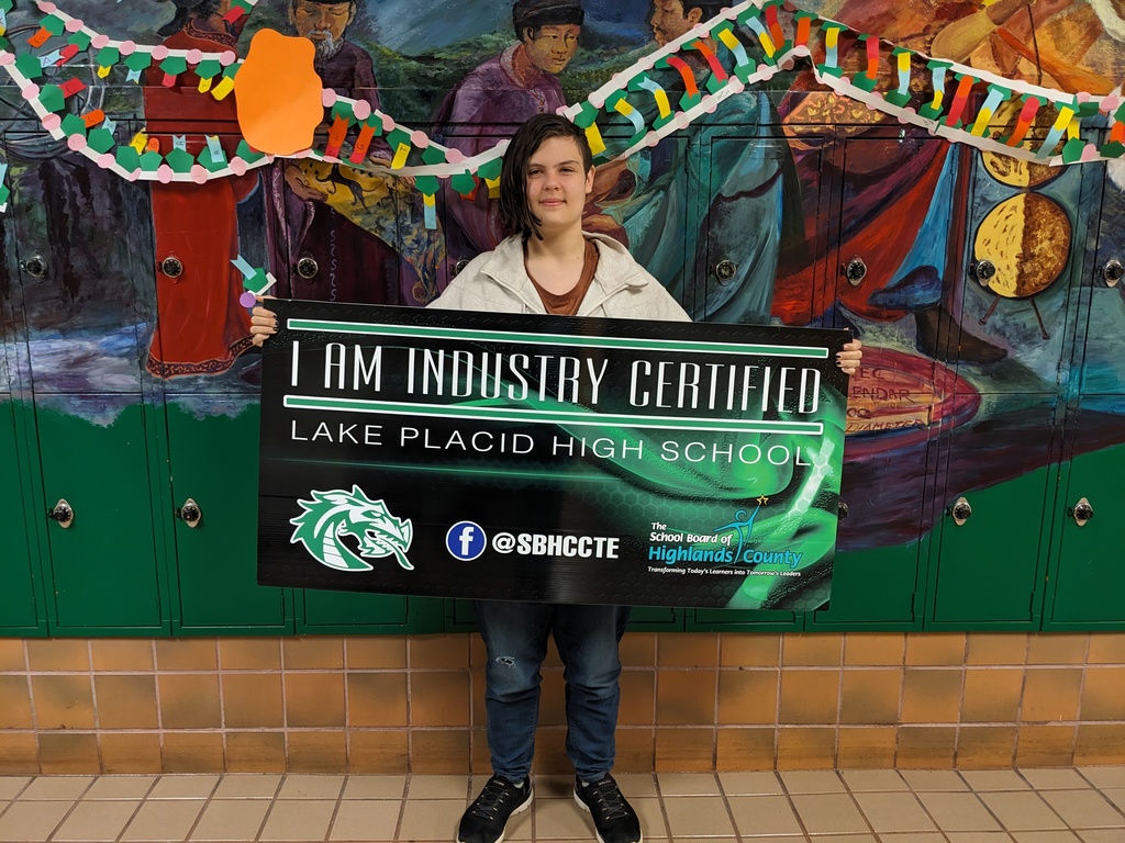 Student holding certificate.
