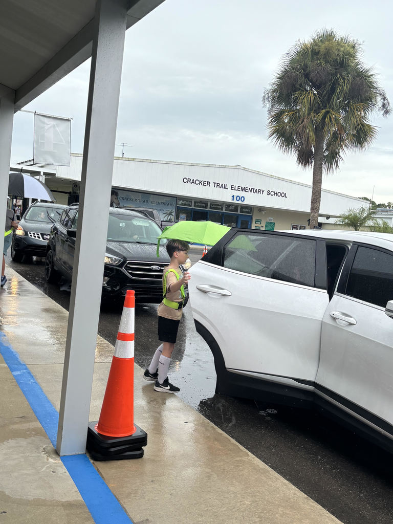 photo of safety patrol helping child in car