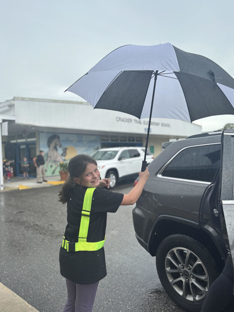photo of safety patrol helping child in car