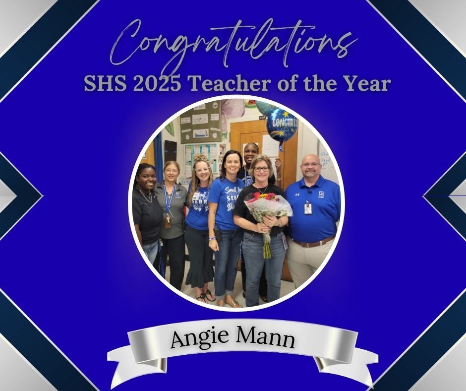 A celebratory graphic on a blue background. The text reads "Congratulations SHS 2025 Teacher of the Year." A photo in the center shows six smiling adults, with one woman holding a bouquet of flowers. A silver banner at the bottom reads "Angie Mann."