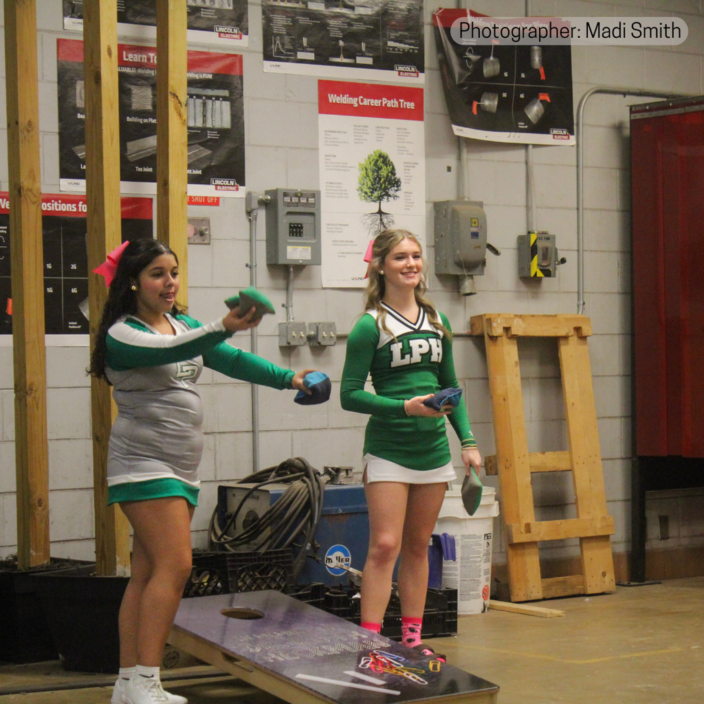 Cheerleaders playing cornhole