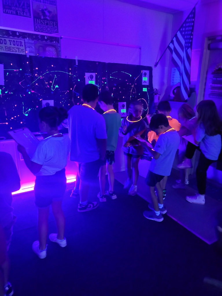 photos of students solving math problems in the classroom (glow in the dark theme)