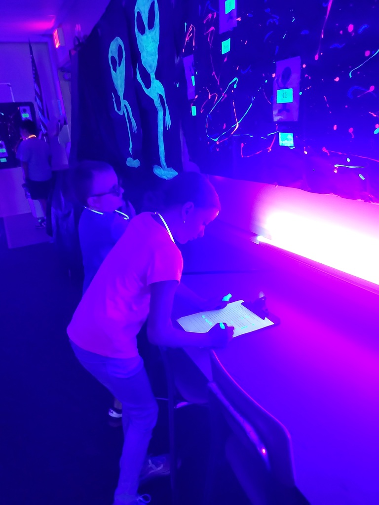 photos of students solving math problems in the classroom (glow in the dark theme)