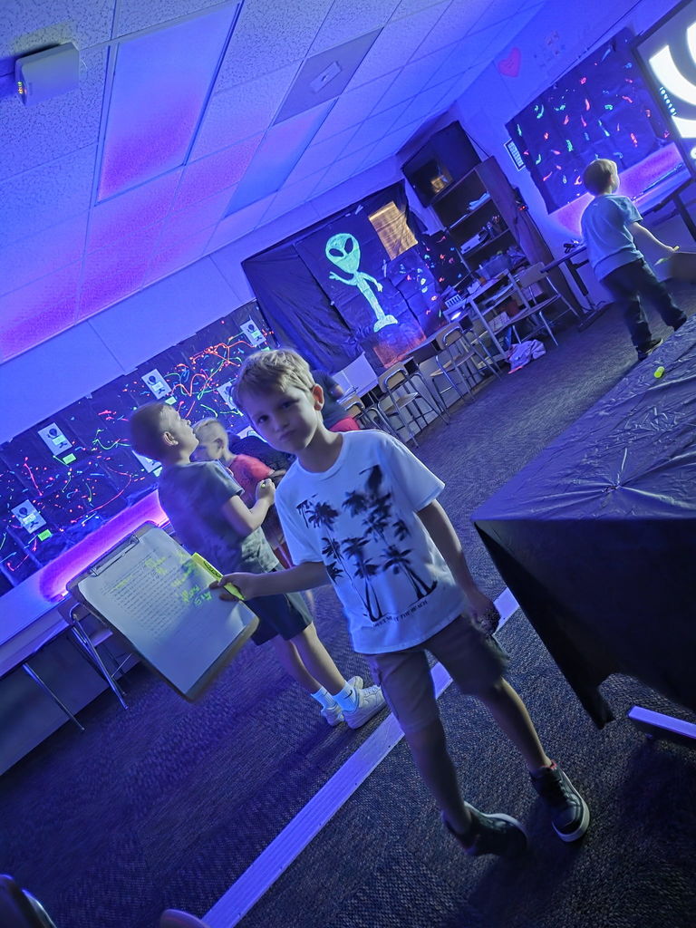 photos of students solving math problems in the classroom (glow in the dark theme)