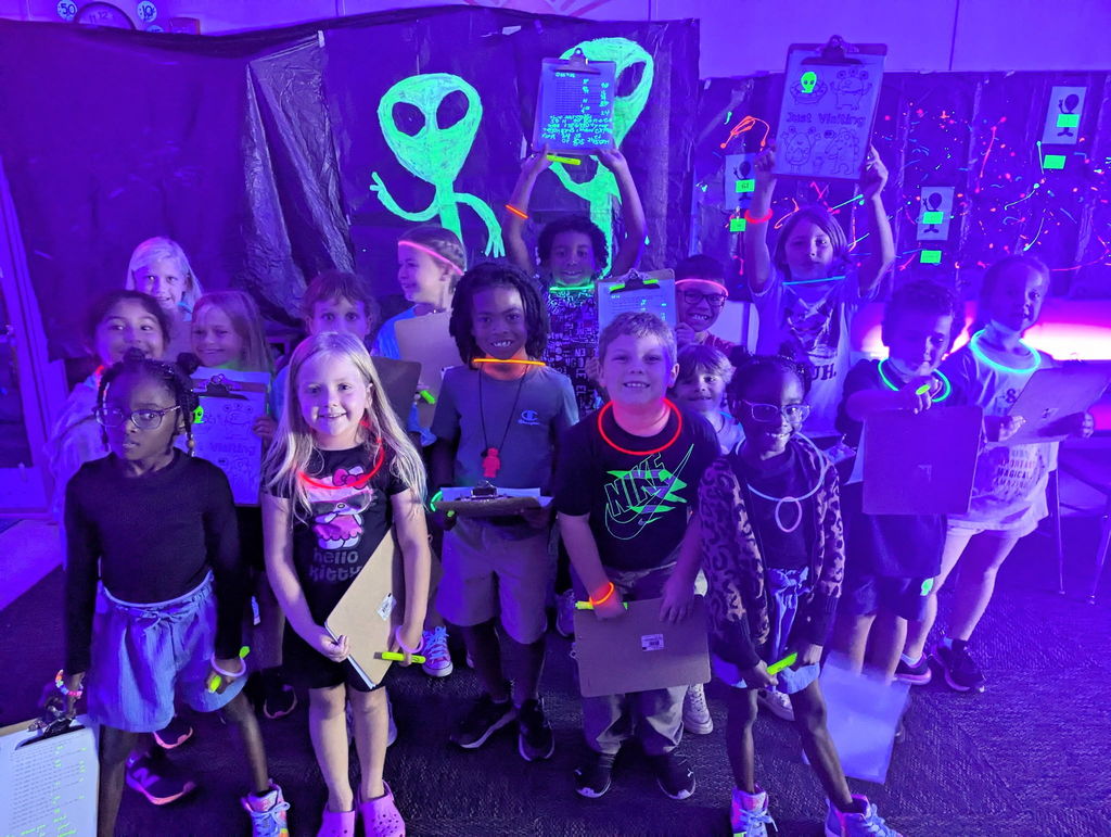 photos of students solving math problems in the classroom (glow in the dark theme)