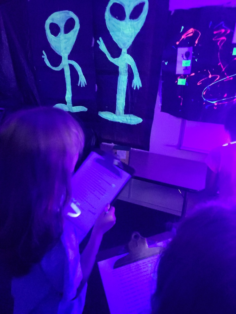photos of students solving math problems in the classroom (glow in the dark theme)