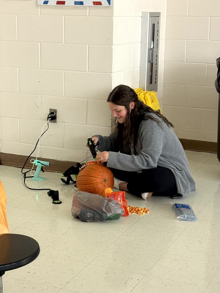 Ms. Hard decorating her grade level pumpkin.