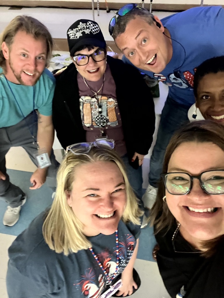 MES Staff enjoying a delicious lunch and staff pumpkin decorating.