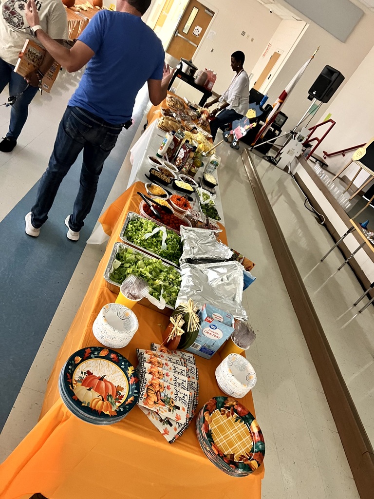 MES Staff enjoying a delicious lunch and staff pumpkin decorating.