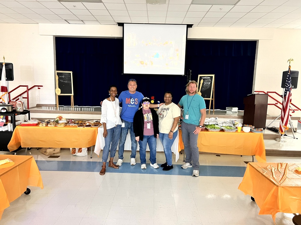 MES Staff enjoying a delicious lunch and staff pumpkin decorating.