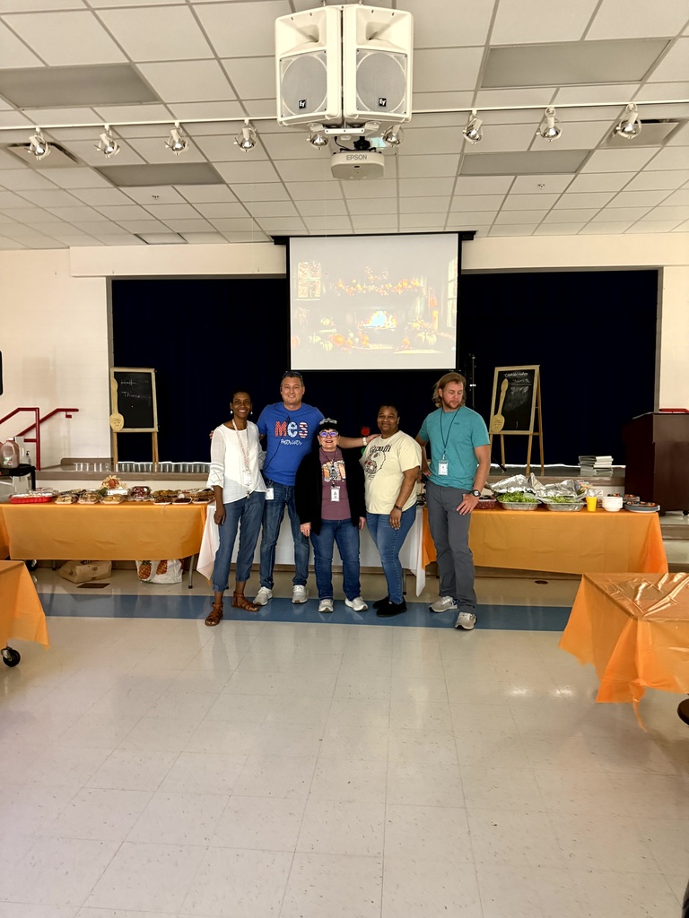 MES Staff enjoying a delicious lunch and staff pumpkin decorating.