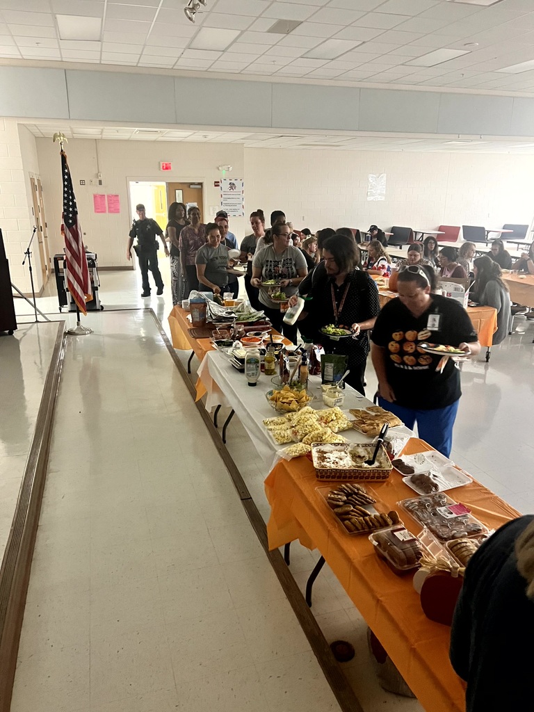 MES Staff enjoying a delicious lunch and staff pumpkin decorating.